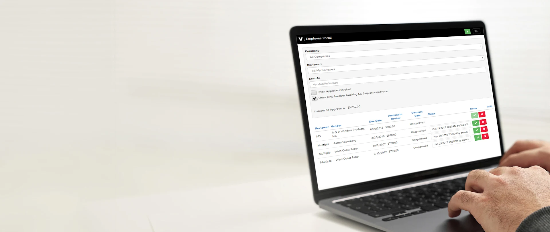 A person uses a laptop to review and approve construction invoices on the Trimble Viewpoint Employee Portal.
