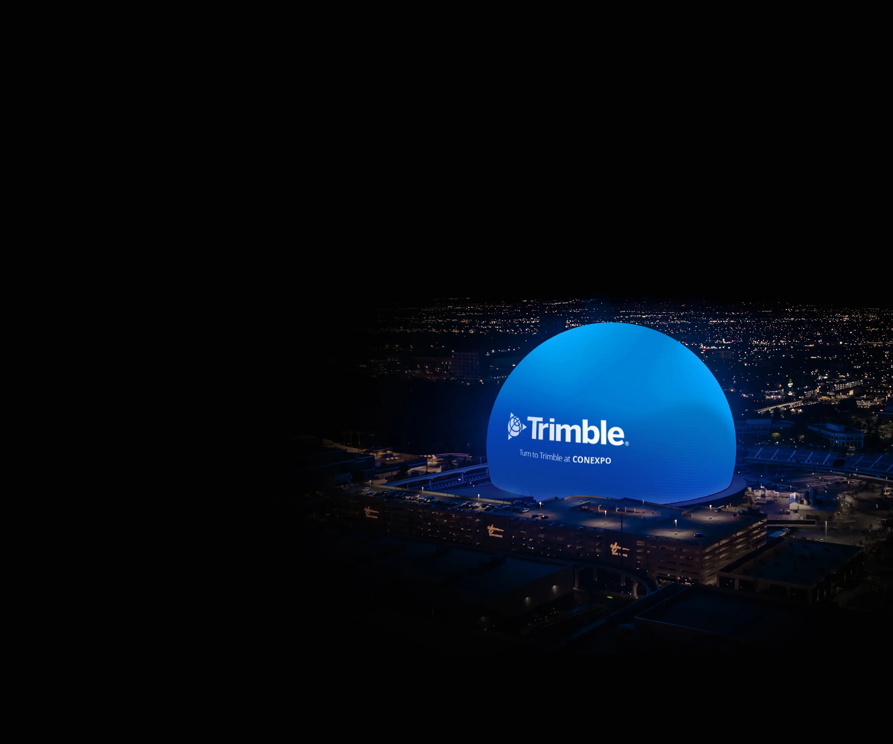 The Las Vegas Sphere illuminated blue at night with the Trimble logo and "Turn to Trimble at CONEXPO" text.