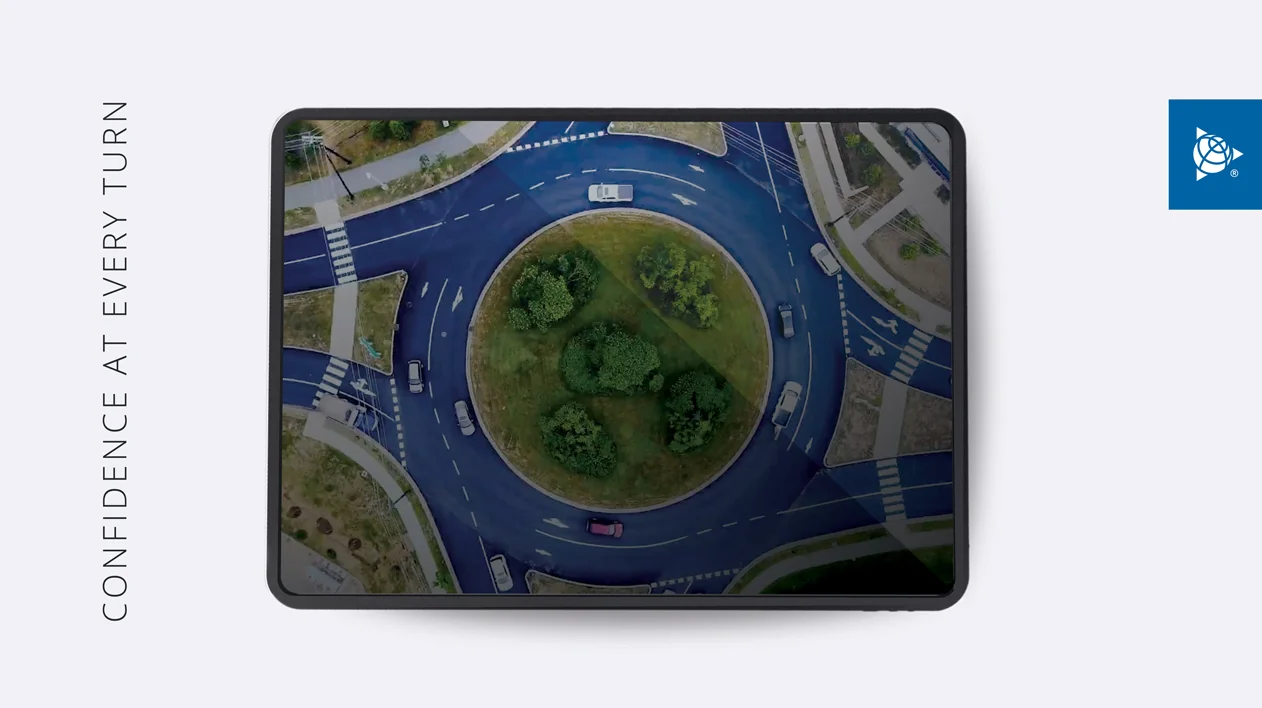 Aerial view of cars navigating a roundabout, with the text "CONFIDENCE AT EVERY TURN" and the Trimble logo.