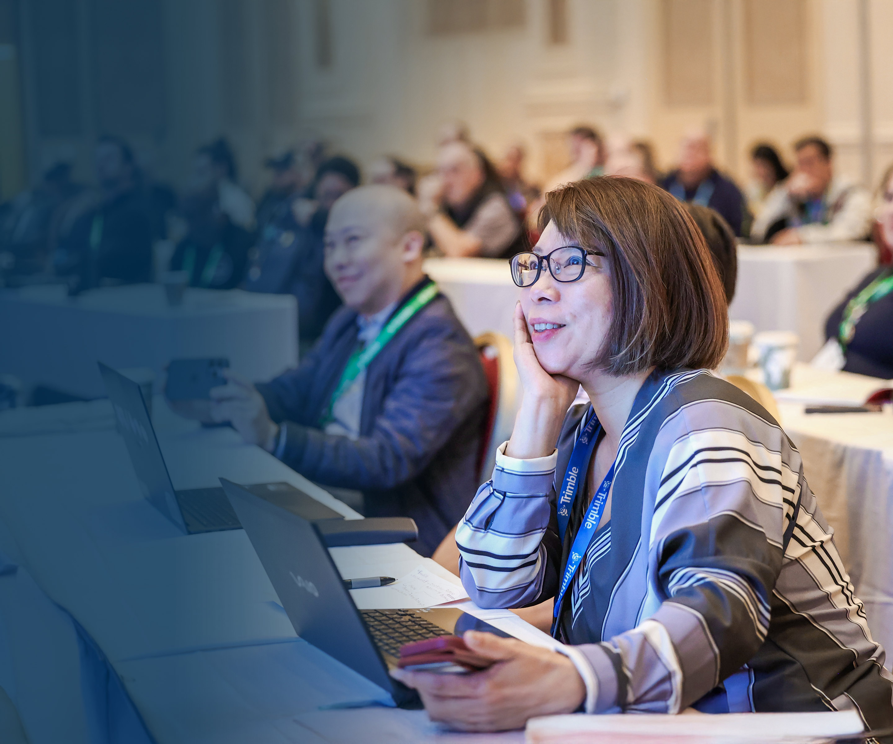 SketchUp users sit in a training session with their laptops and smile towards the front of the room during the 3D Basecamp Summit.