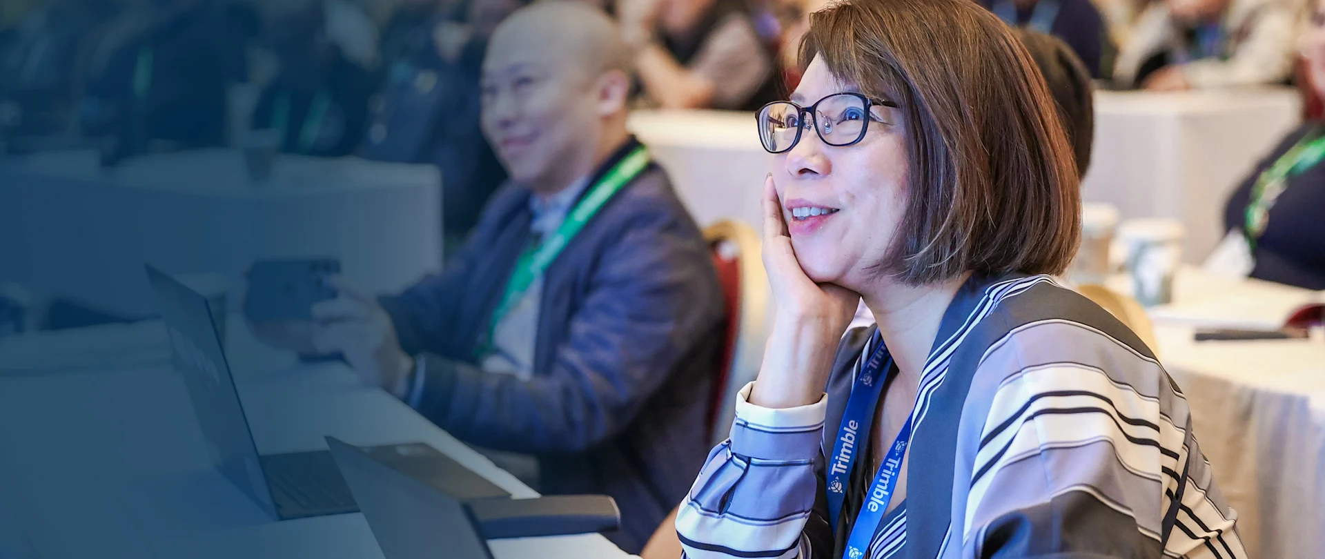 SketchUp users sit in a training session with their laptops and smile towards the front of the room during the 3D Basecamp Summit.