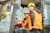 People in hard hats and Trimble vests operating heavy machinery