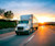 Semi-truck on highway at sunset