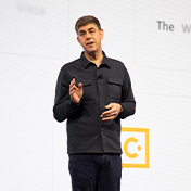 Rob Painter, CEO of Trimble, speaks on stage in front of the Trimble Connect logo at a corporate event.