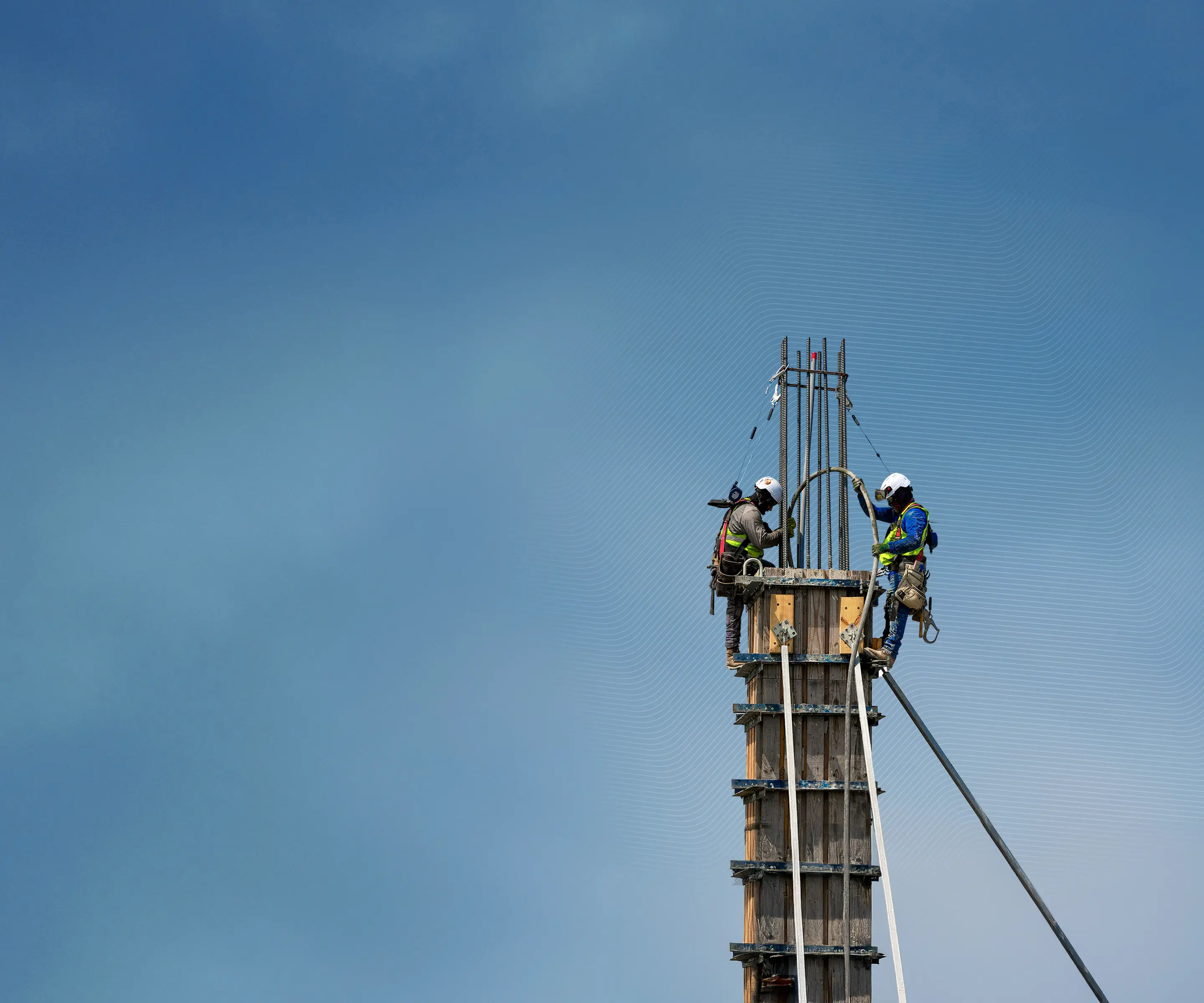 Two construction workers on a column at the Waterline tower in Austin, Texas, a project utilizing Trimble digital construction technology.