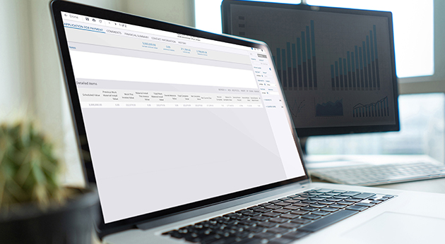 This image shows a laptop screen displaying the **Trimble ProjectSight** "Application for Payment" interface, with a second monitor showing data charts.