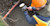 Worker on a jobsite holding a mobile phone with sitevision software attached to a trimble antenna