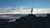 Man using Trimble Geospatial equipment on top of mountain in evening