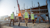 Workers wearing reflective vests and hardhats walking towards building under construction