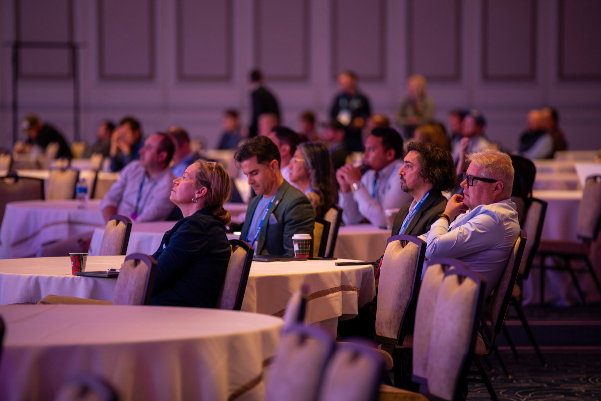 Dimensions attendees focus in on a session taking place on the mainstage in the Venetian Ballroom.