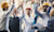 several workers cheering hands in air