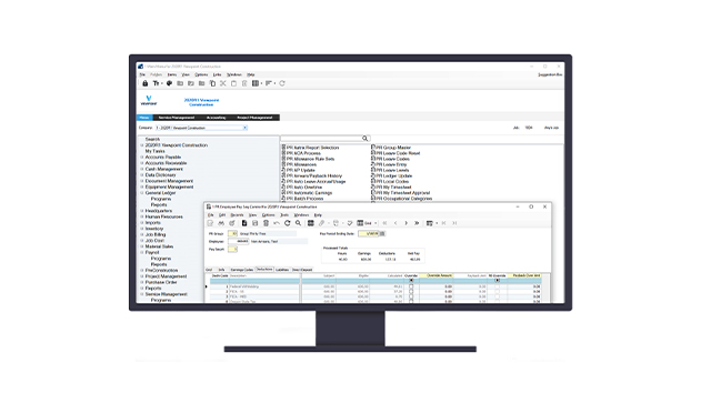 A computer monitor displays Trimble's Vista by Viewpoint construction ERP software with an active employee payroll management window.