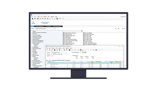 A computer monitor displays Trimble's Vista by Viewpoint construction ERP software with an active employee payroll management window.