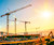 Upward view of construction site with cranes
