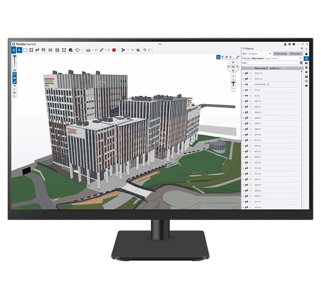 A desktop monitor displays Trimble Connect software