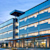 Modern glass facade of the Trimble corporate headquarters in Westminster, Colorado, illuminated at twilight.