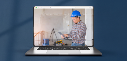 A laptop displays an image of an engineer in a hard hat using a tablet to digitally manage documents on a jobsite.