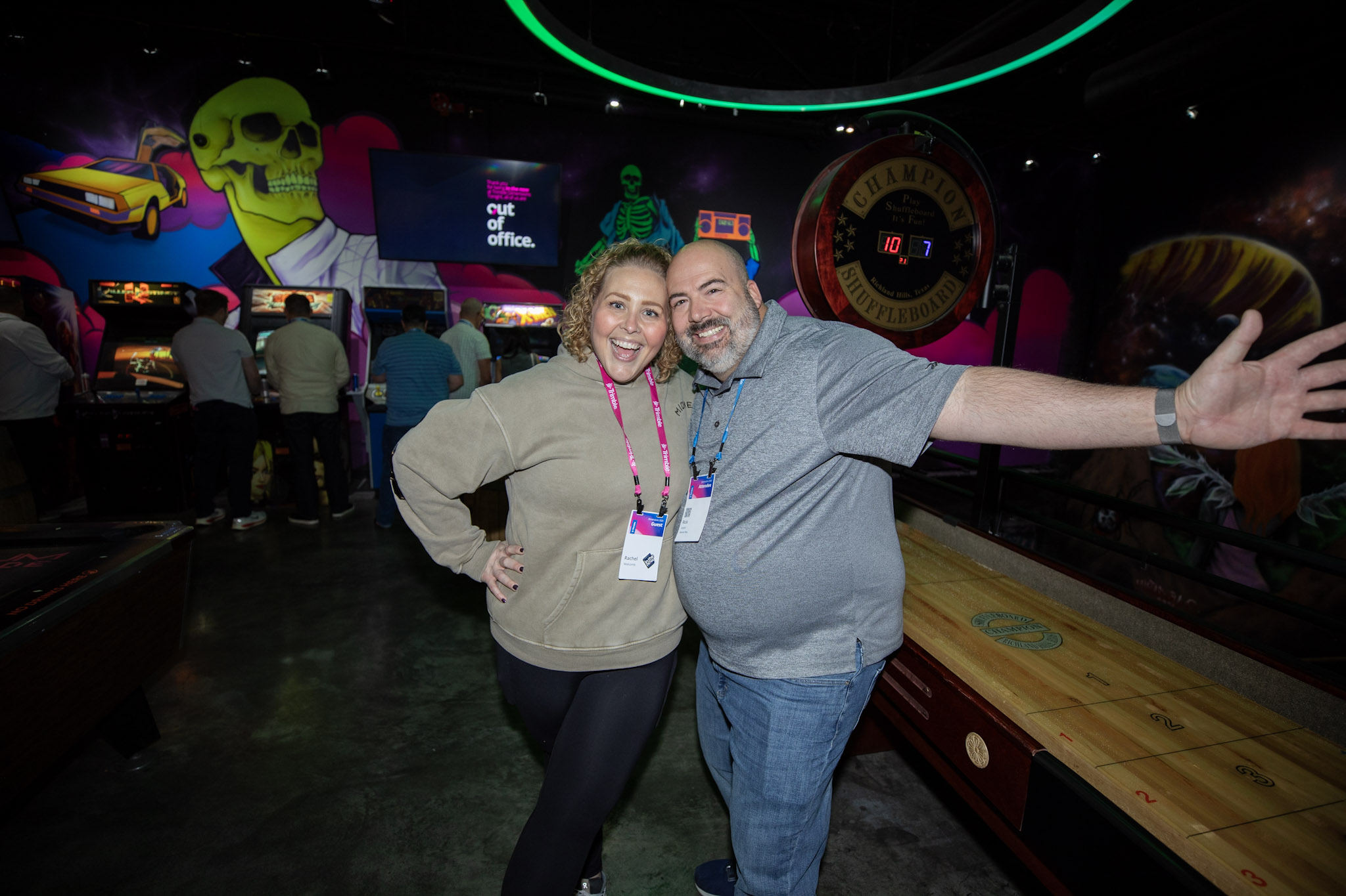 A Trimble Dimensions attendee and his guest smile for the camera at the Customer Appreciation Party at AREA15.