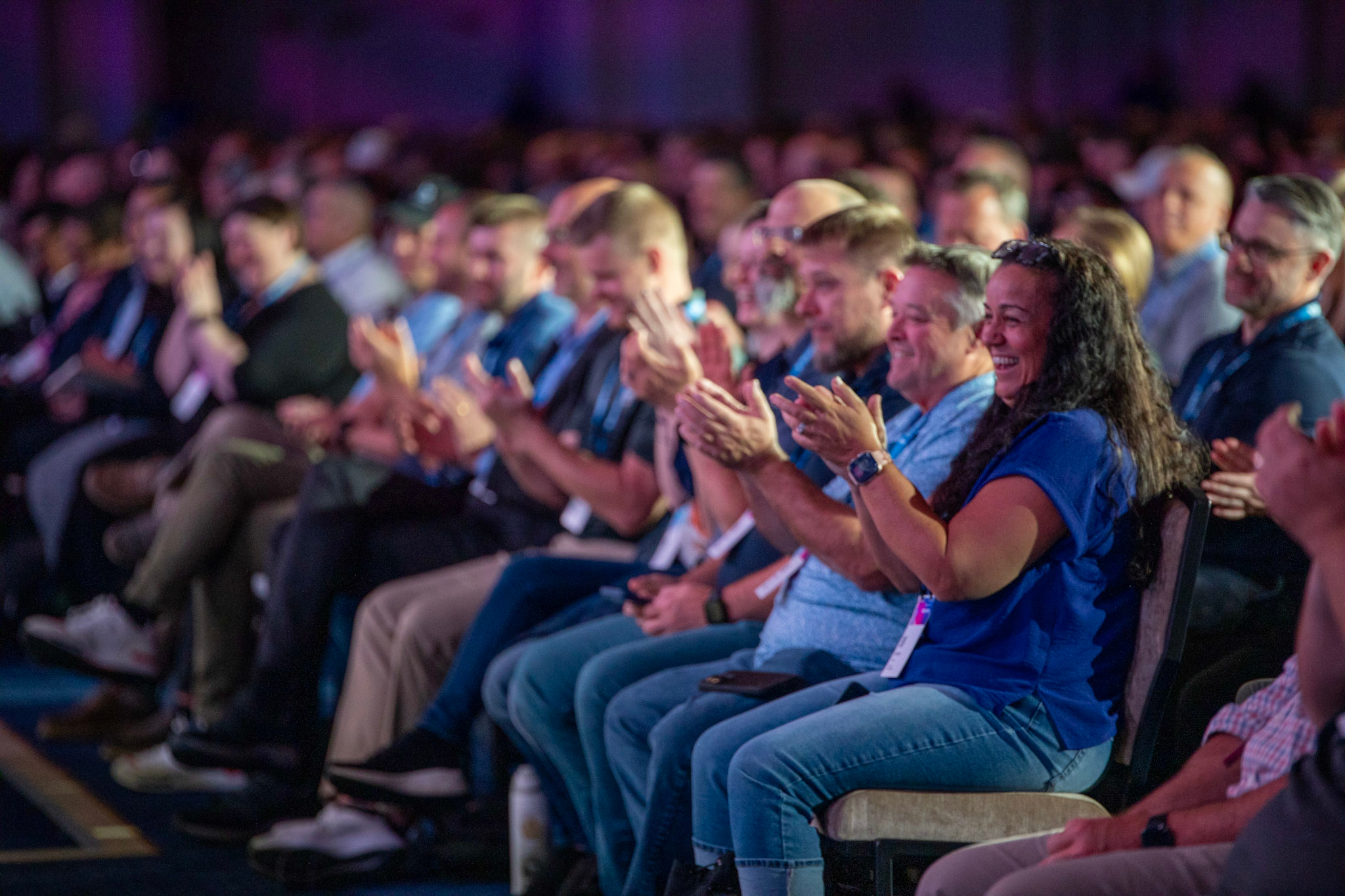 Attendees laugh and applaud while watching the keynote in the Venetian Ballroom.
