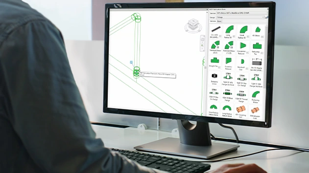 A person's hands are visible on a keyboard while a computer screen displays Trimble-managed ITM library
