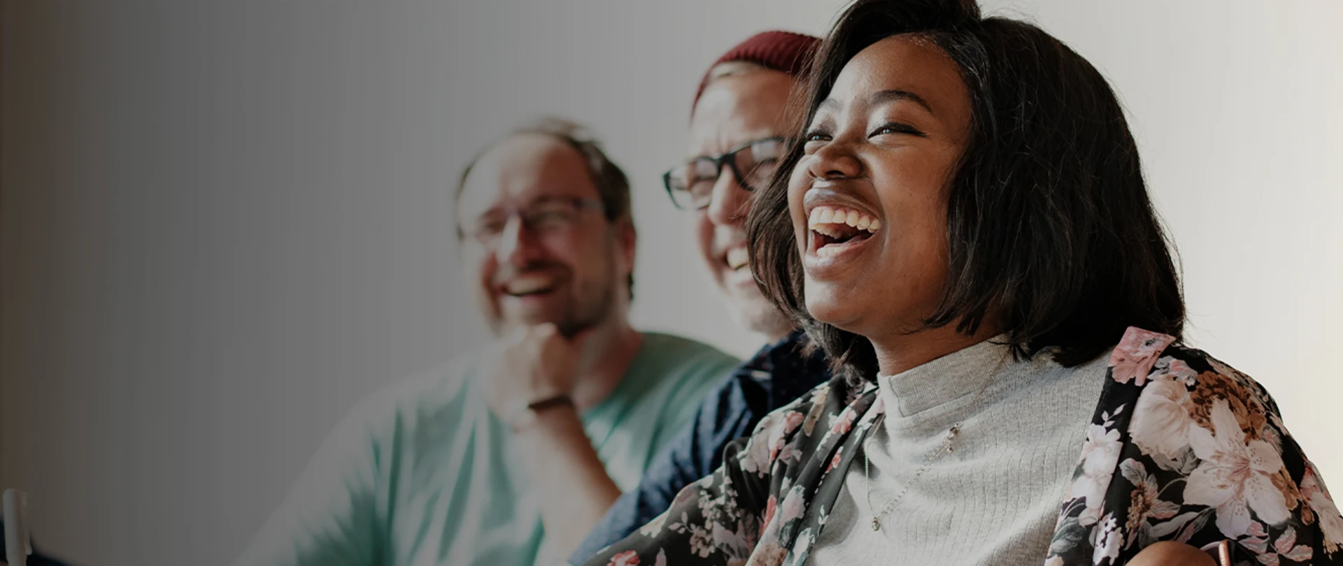 Group of business professionals smiling with woman in foreground