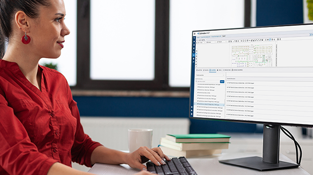 A woman in a red shirt works on a computer, viewing a detailed material and assemblies library within Estimation MEP software.