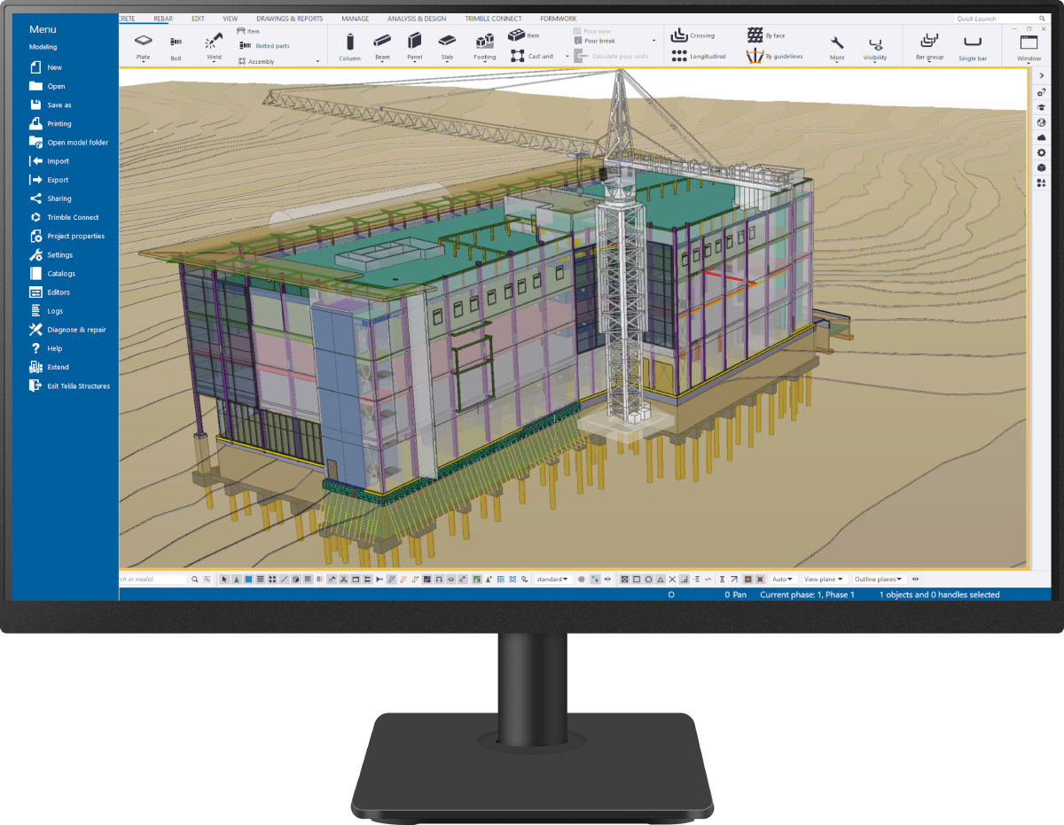 Computer monitor showing a detailed 3D building model and tower crane in the Trimble Tekla Structures BIM software interface.