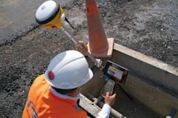 Man using Trimble antenna and handheld tablet