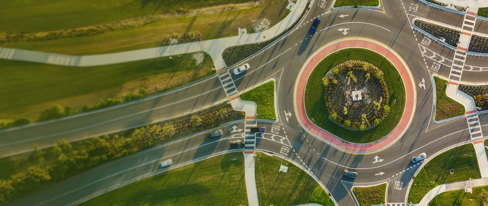 Aerial view of a modern roundabout with cars, a key visual for Trimble’s "Confidence at every turn" campaign for infrastructure solutions.