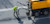 Road construction worker sealing crack in pavement using heavy machinery
