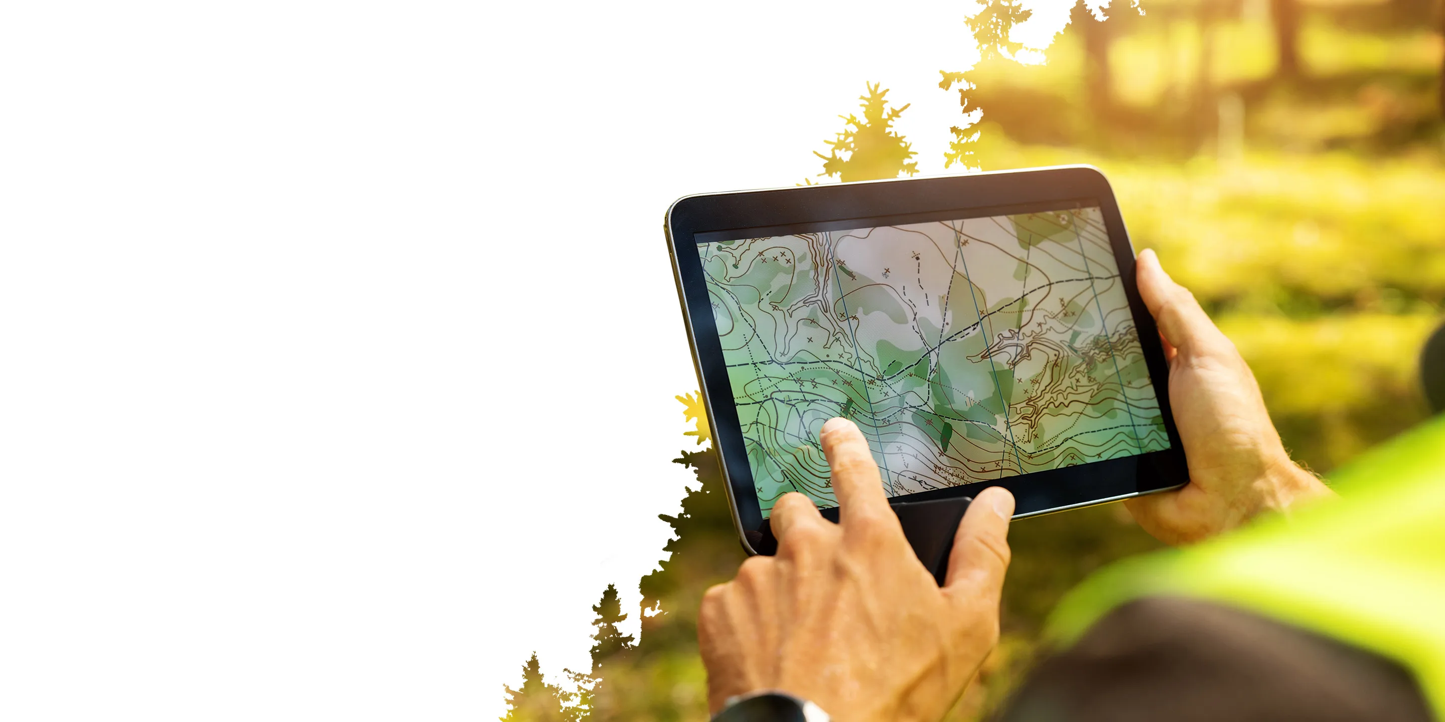 Hands holding a tablet displaying a topographic map. The background is a sunny, blurred outdoor environment, suggesting a fieldwork context.