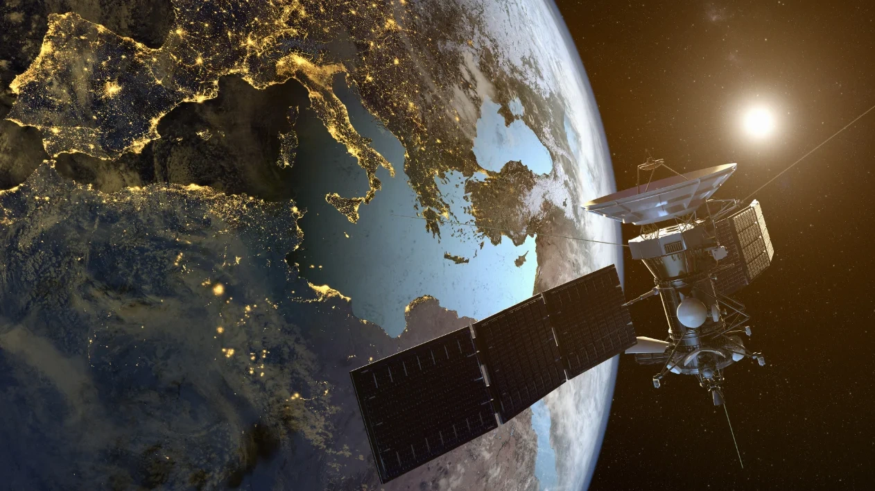 A high-resolution satellite in Earth's orbit positioned over east region at night, illustrating global GNSS connectivity and geospatial data coverage.