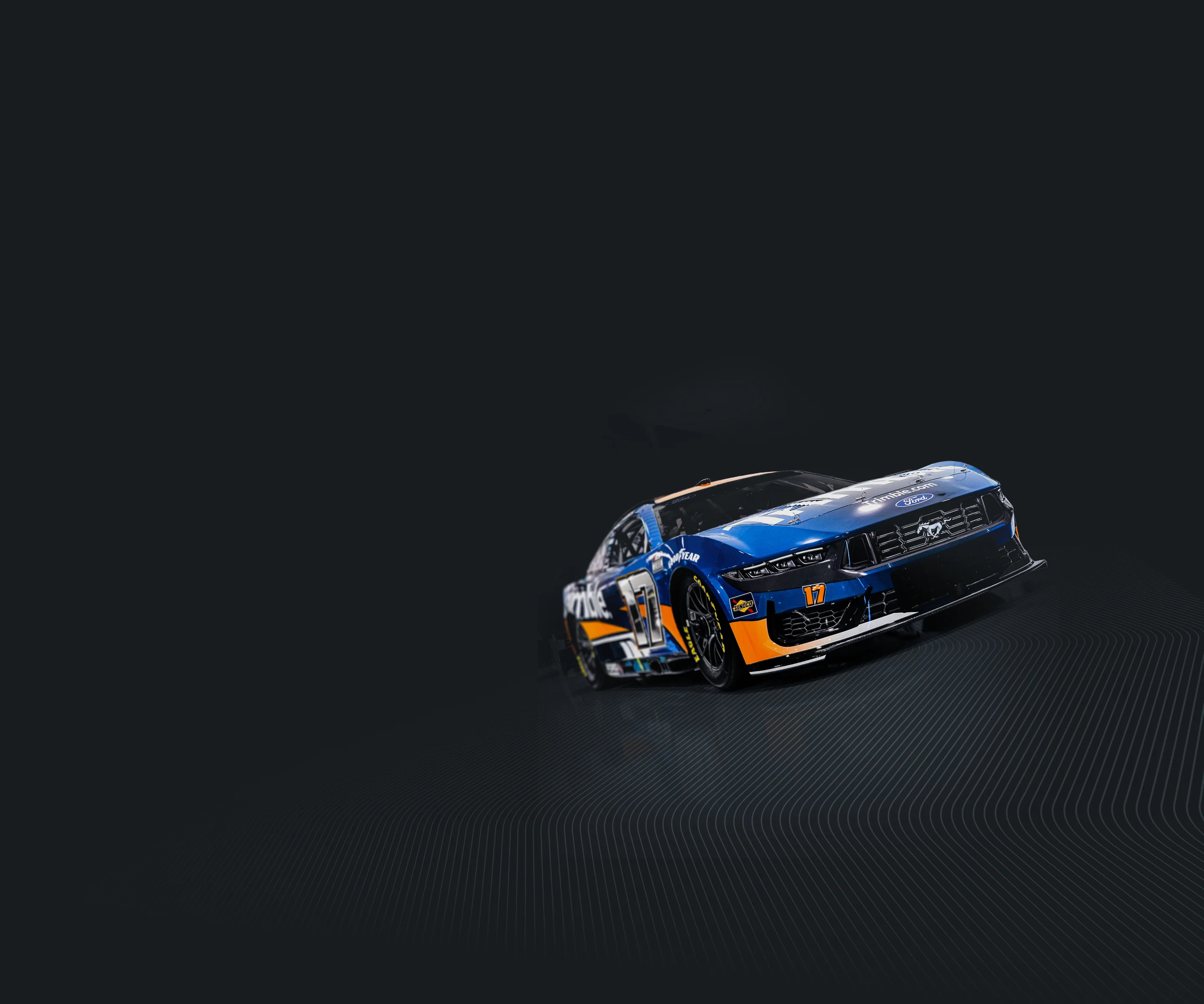 The number 17 NASCAR race car features a blue and white Trimble livery with yellow accents and Chris Buescher's name on a dark background.