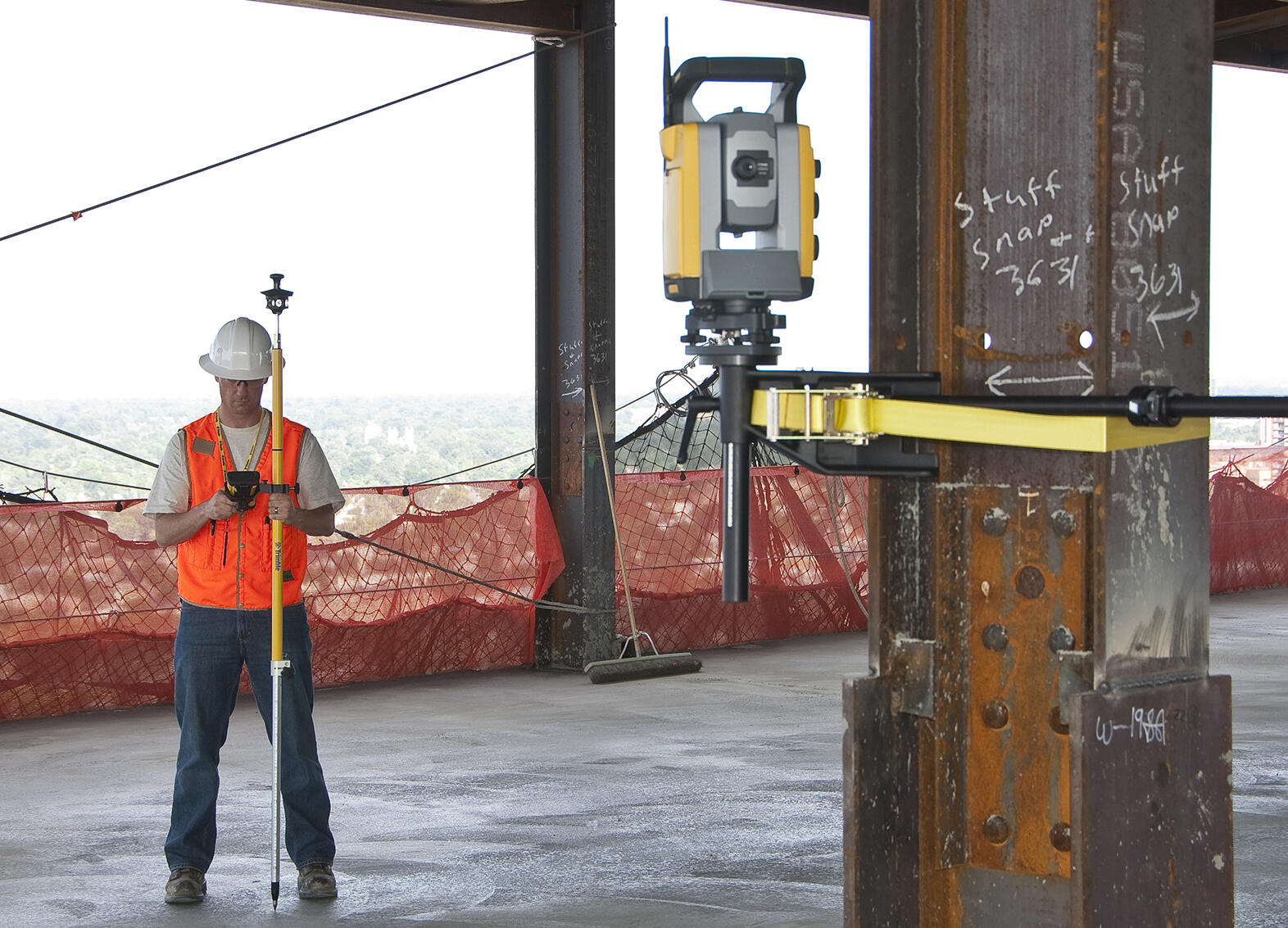 Man using a robotic total station in a building