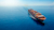Shipping container from above navigating in open ocean
