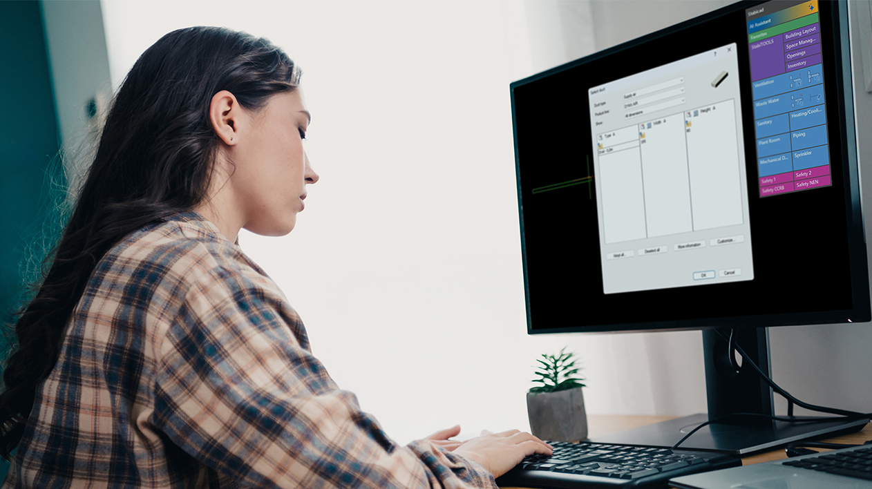A woman using a computer with Stabicad for IntelliCAD software displayed on the screen.
