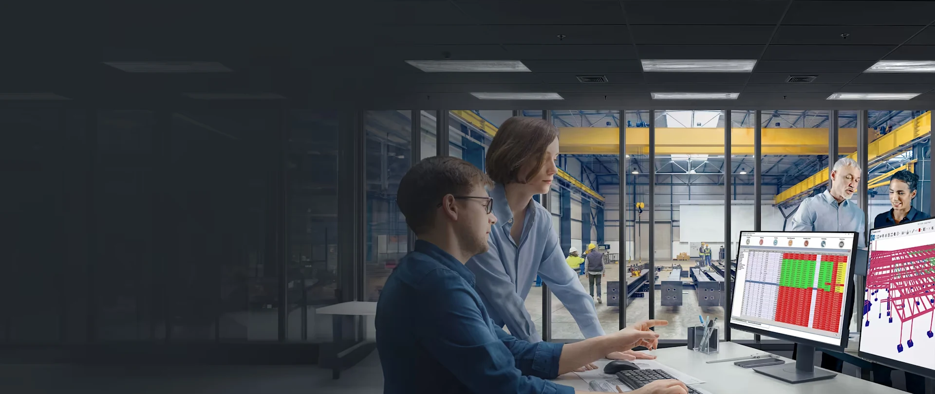 Two professionals use Tekla PowerFab and Tekla Structures software in an office overlooking a steel fabrication facility.
