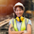 Woman in safety gear smiling at camera with arms folded