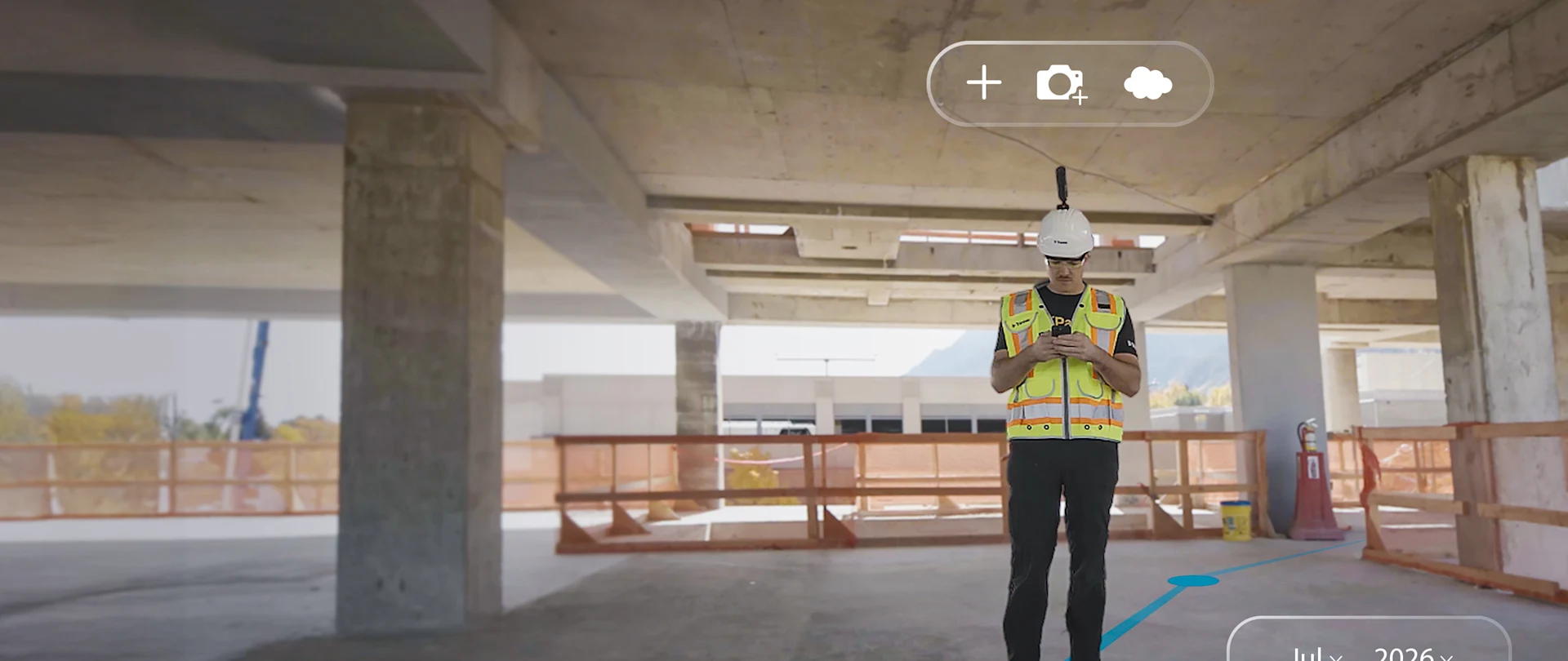 Construction worker on a building site using a ProjectSight 360 Capture app on a phone. AR overlays display a calendar and data.