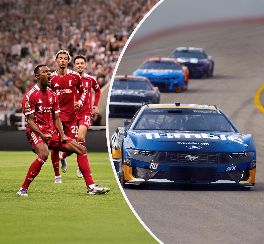 Athletes from Liverpool Football Club on left with Trimble car on left and Trimble-branded RFK Racing car on right.