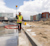 A surveyor uses a Trimble R12i GNSS receiver and TSC7 controller at the Global Intermediate Academy construction site in Denver.