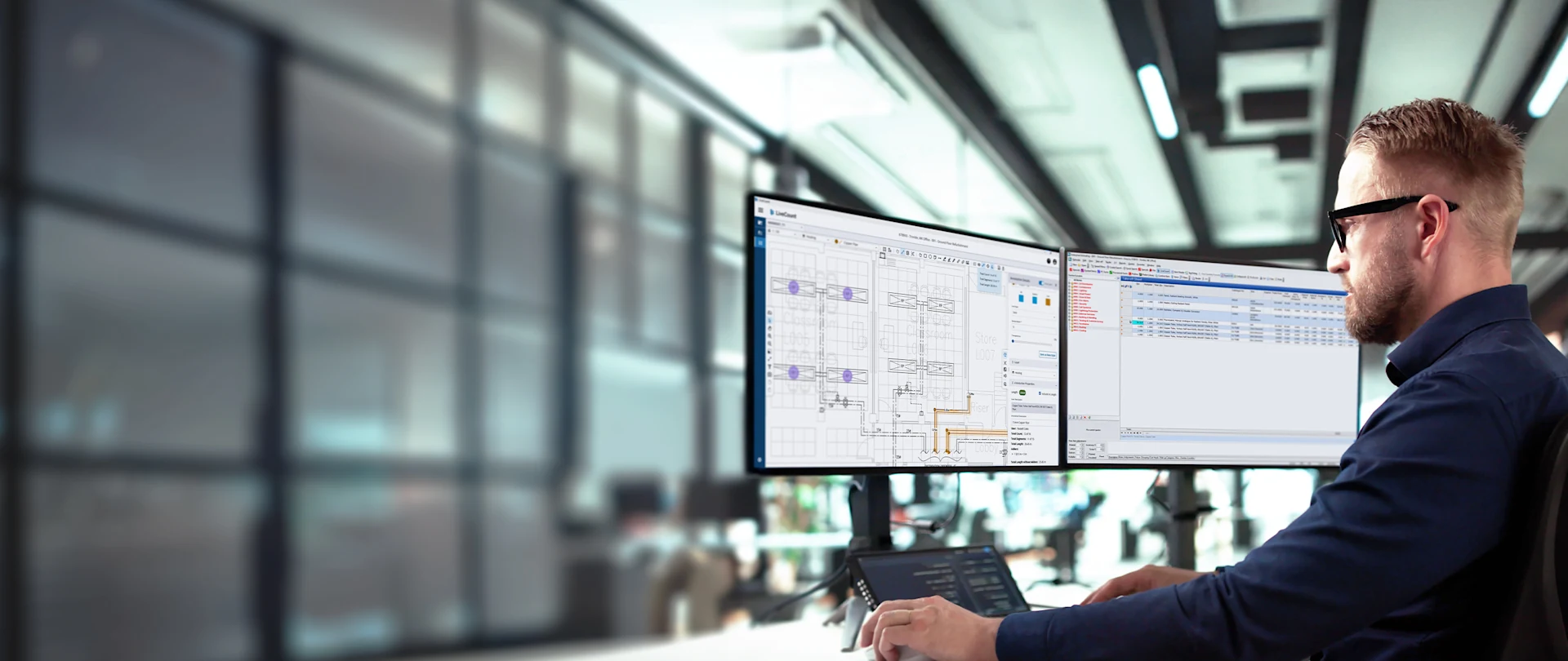 A man using Total Estimating software on dual monitors in a modern office.