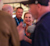 A smiling Cyndee Hoagland, Trimble SVP, networks at a corporate event with attendees wearing blue branded lanyards.