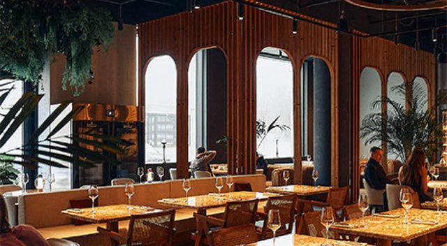 With warm lighting and breath-taking ambiance, the restaurant depicted reminds the viewer that elegance is built into the architecture long before the first plate is served.