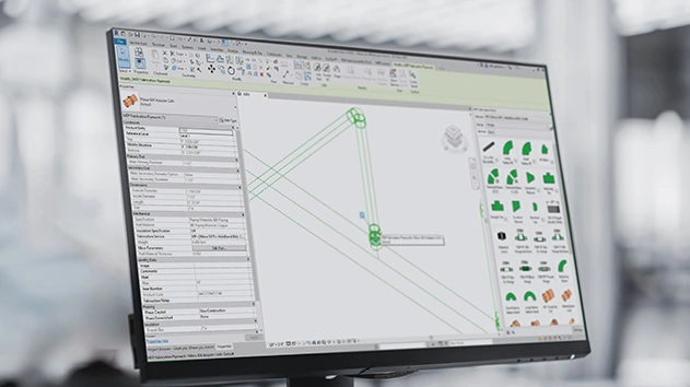 A close-up of a computer monitor showing a 3D model with a library of pipe fittings on the right.