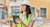 A woman in a white hard hat and yellow safety vest smiling while holding a tablet at a construction site.