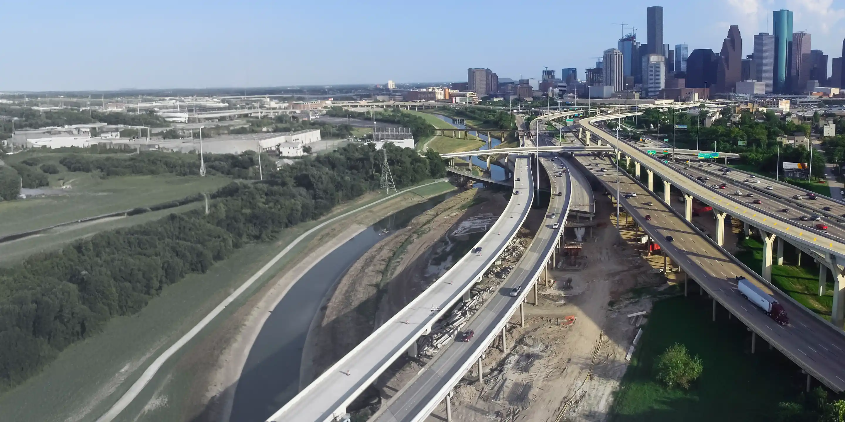 This aerial view shows the Houston, Texas skyline and the I-10/I-45 highway interchange, a site for Trimble infrastructure solutions.