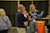 At a trade show booth, a Siteline representative shows software on a laptop to attendees near an orange Yeti cooler bag and a prize sign.