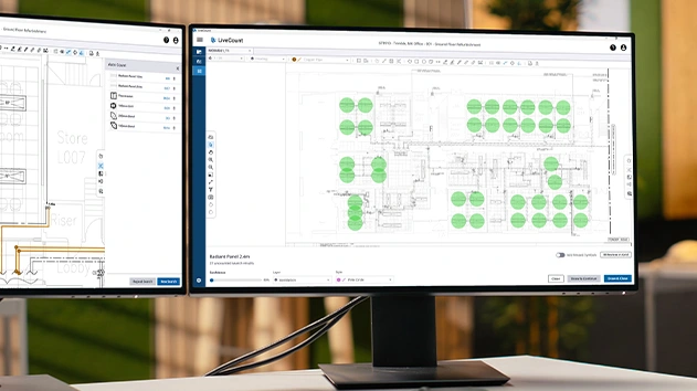 A desk with two monitors showing MEP drawings in LiveCount software.