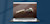 Laptop showing concept of tractor pulling coins on dirt